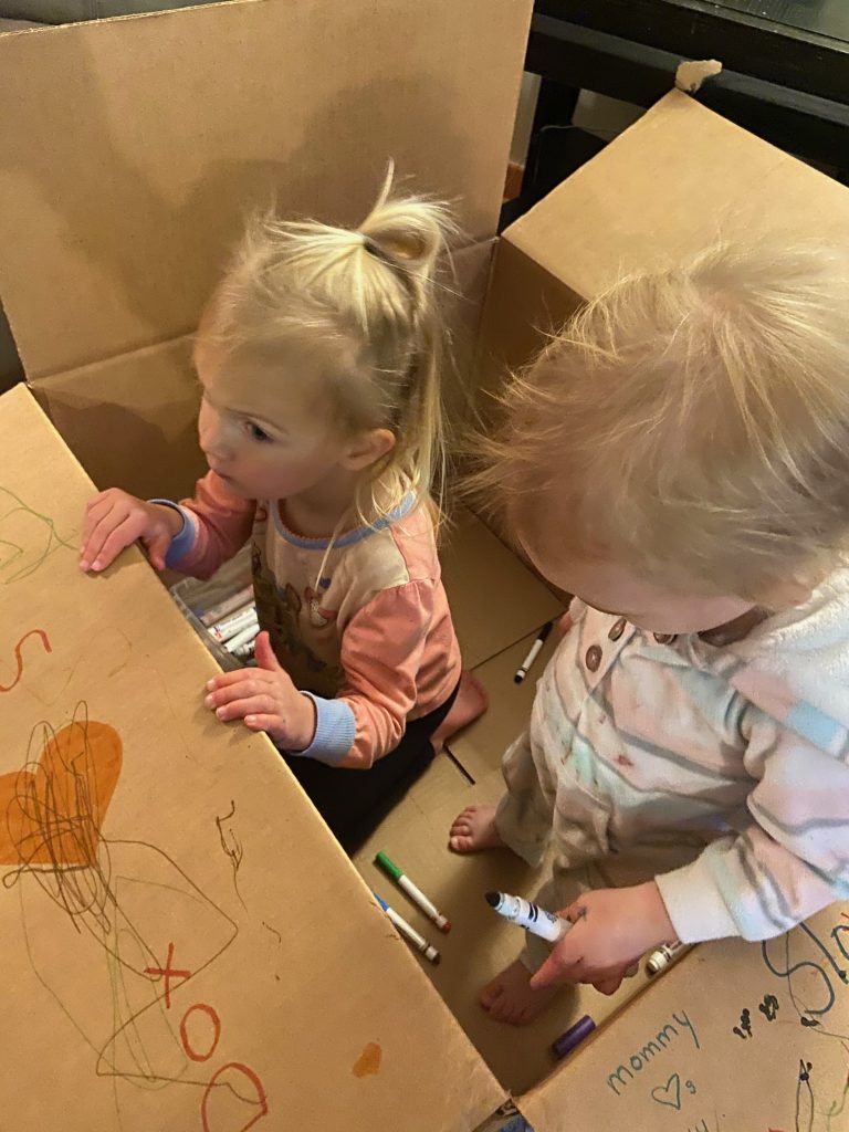 Teamwork makes the dream work when it comes to decorating a cardboard box! Photo c/o Janelle V.