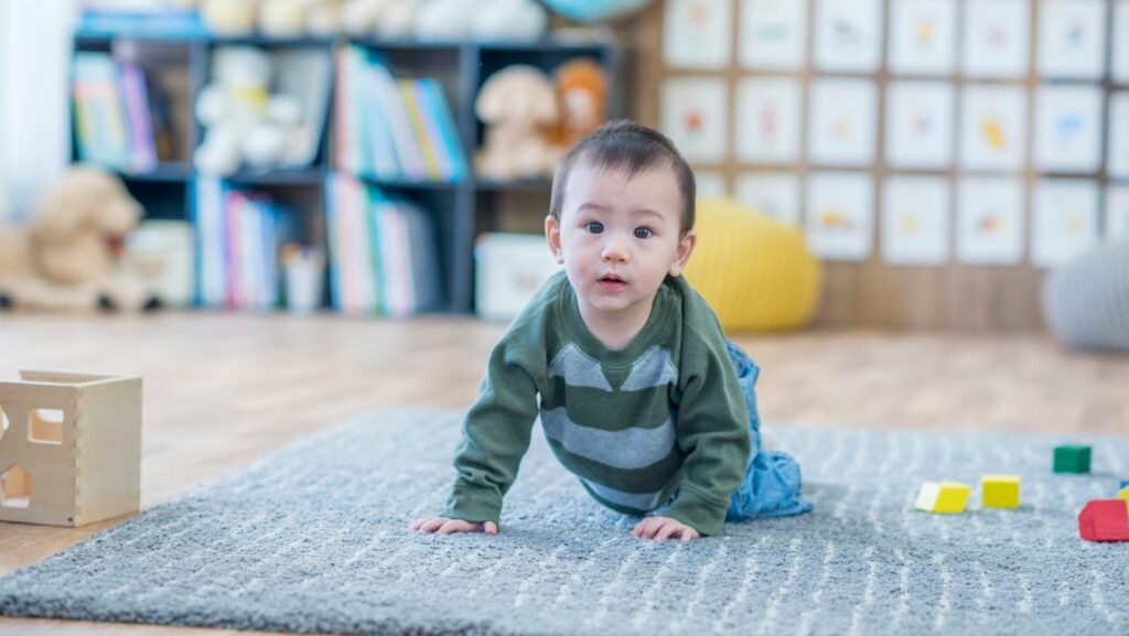 baby crawling on a carpet at a parent support group