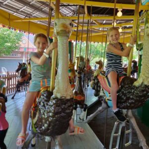 girls riding the carousel at Lakeside Park