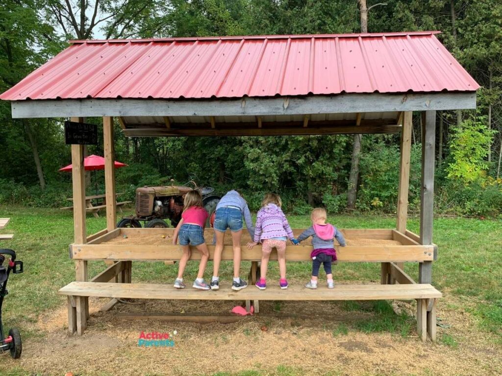 kids playing at the sand table at the Apple Orchard