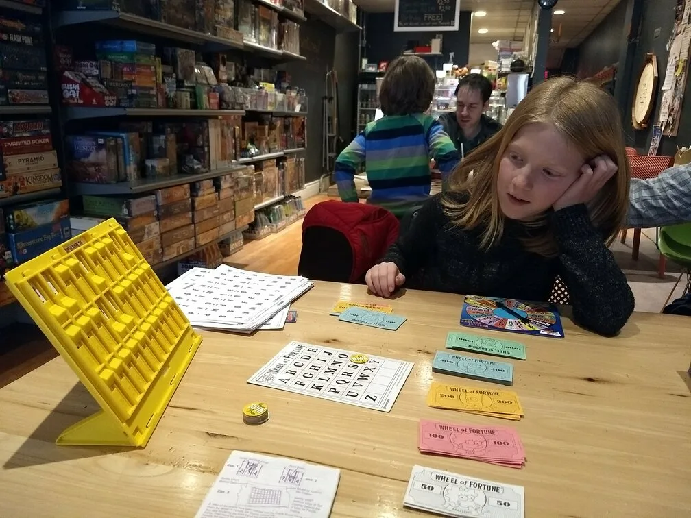 elizabeth playing at mancala monk board game cafe in Hamilton ontario