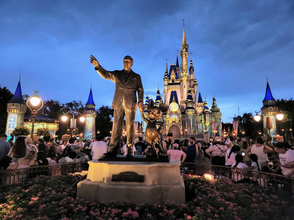 Walt Disney and Mickey statue in front of the castle. Photo courtesy of Jennifer Malcew Timeless Tales Travel disney-focused travel agent